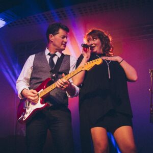 The band "Double Talk" performing on a stage.